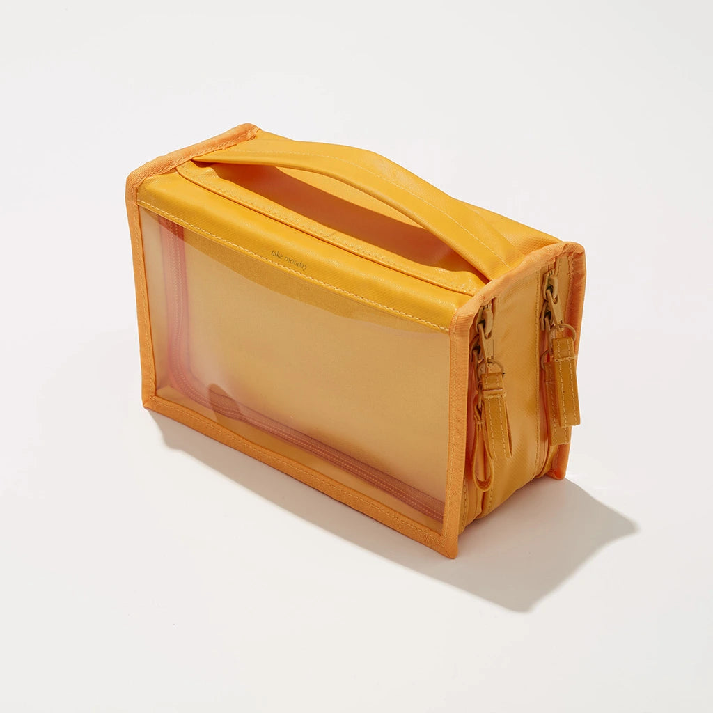 Bright yellow rectangular travel organizer bag with a clear front panel a sturdy top handle dual side zippers and subtle take mooday branding on a crisp white background